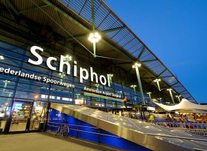 The entrance of Amsterdam Airport Schiphol in the evening. Schiphol is located 9 kilometers southwest of Amsterdam.